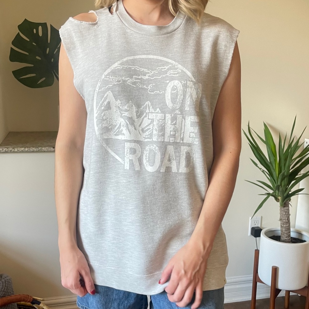 Distressed sleeveless sweater.